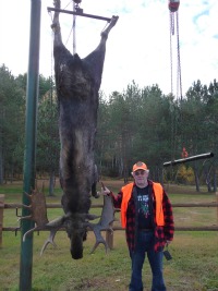 A hunter poses with his moose