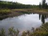 Lake with moderate hills surrounding it.