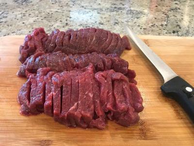 Sliced moose steak with fat and gristle removed